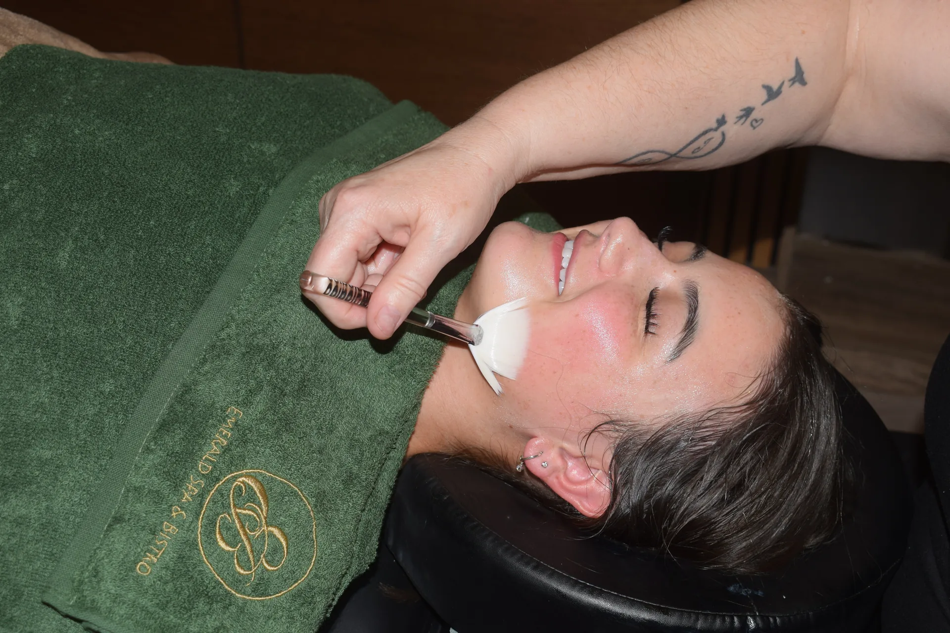 A warm towel and mask step during a facial at Emerald Spa & Bistro