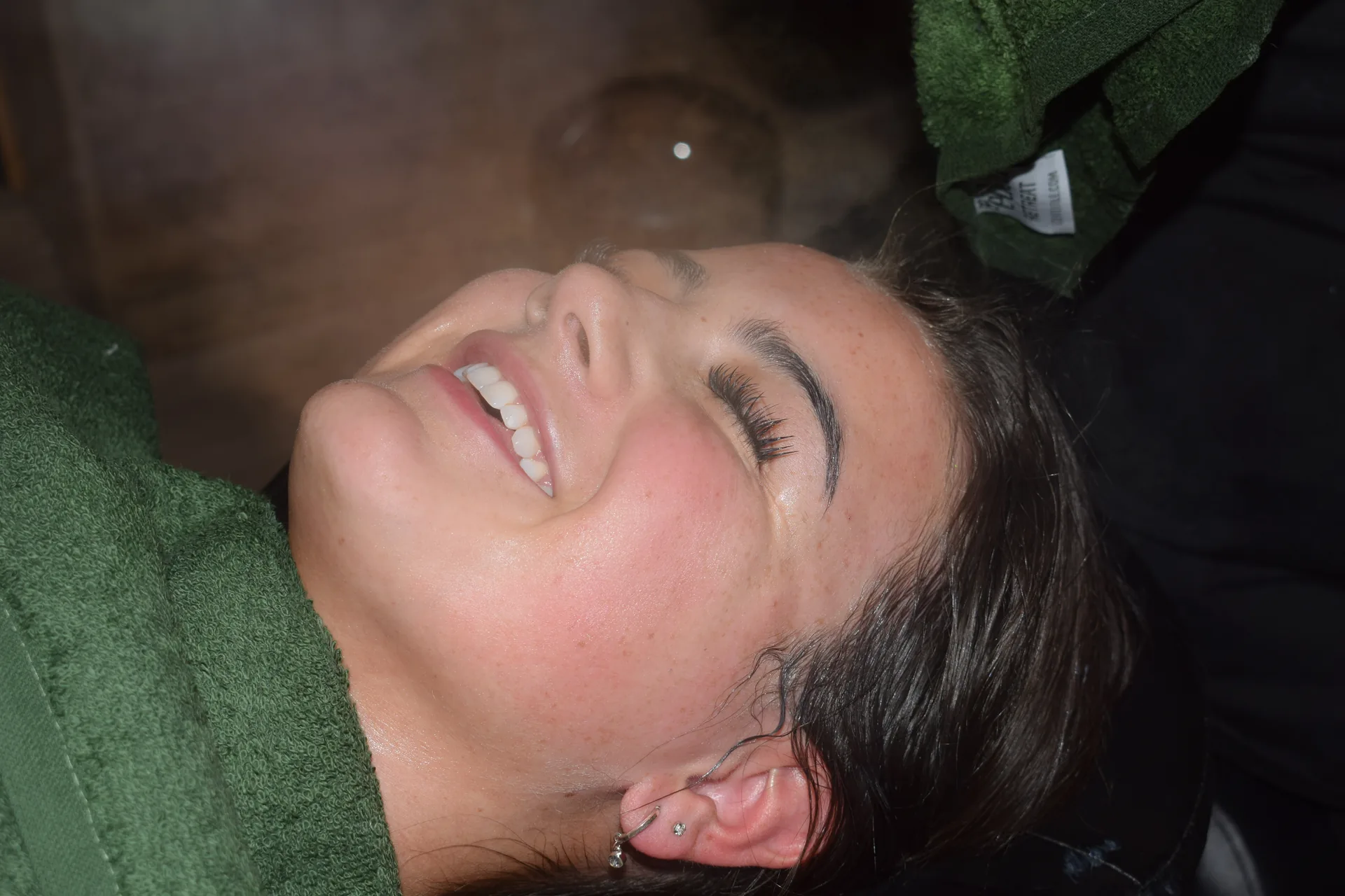 A guest with glowing, refreshed skin after a facial at Emerald Spa & Bistro