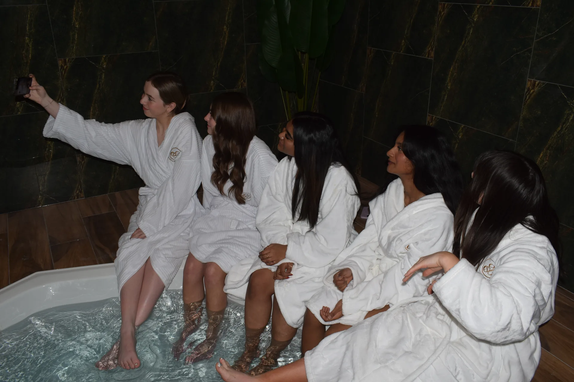 Friends enjoying the hydro spa together in robes at Emerald Spa & Bistro