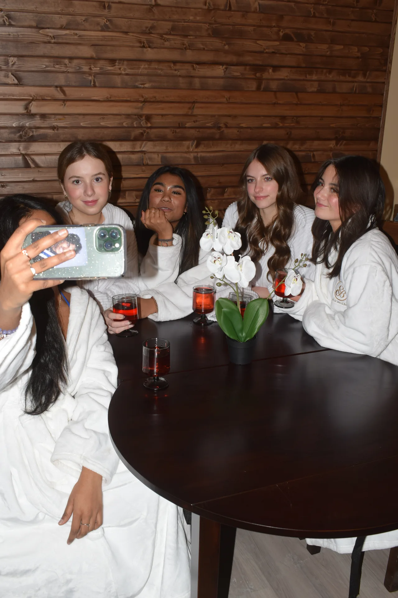 Guests relaxing in robes with drinks after a massage at Emerald Spa & Bistro