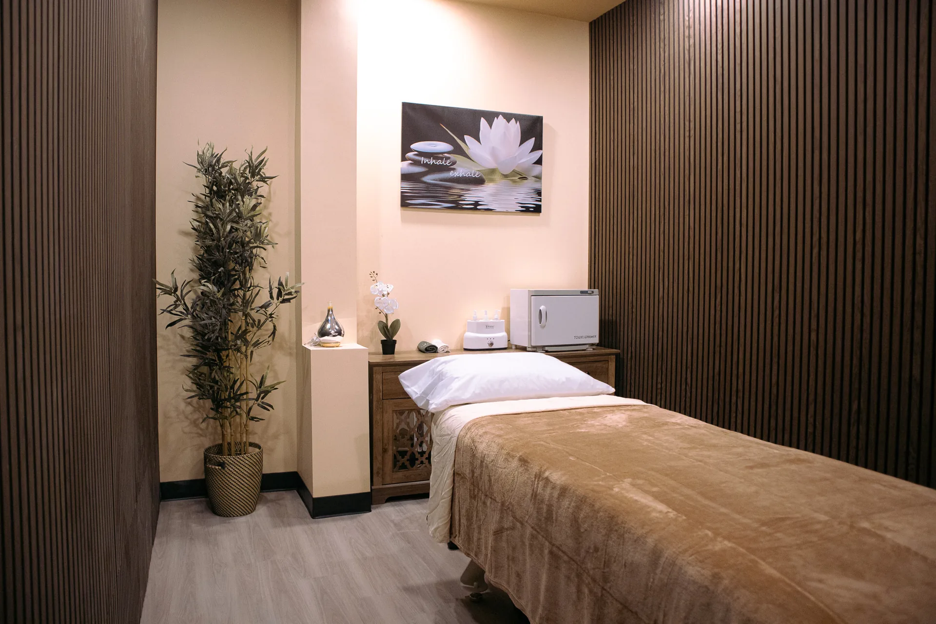 A warm, private massage treatment room at Emerald Spa & Bistro in Sherwood Park